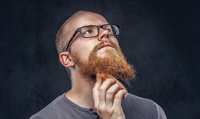 man using a beard brush